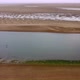 Drone Shot of Water Stream and Sand with Bird Flying Across Norfolk - VideoHive Item for Sale