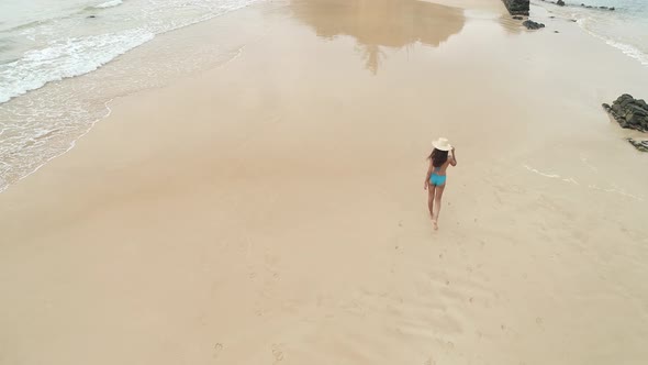 Flyover Latino Girl In Bikini Walking On Beach