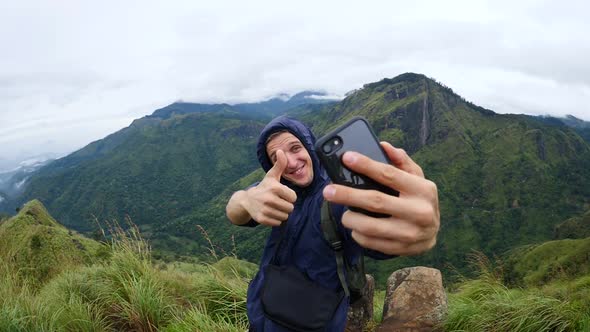 Hiker Taking Selfie On Top Of Mountain