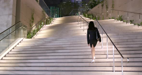 Businesswoman walking downstairs in the city