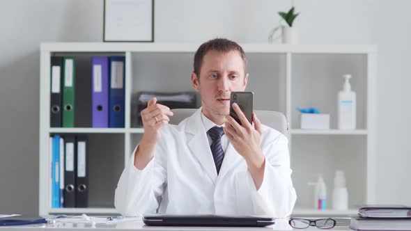 Professional medical doctor working in hospital office using computer technology.