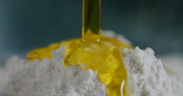 Olive Oil is Being Poured to the Flour in Slow Motion