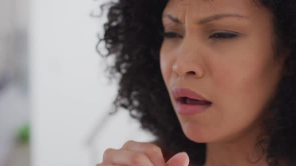 Close up view of woman coughing at home