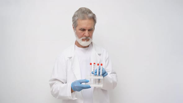 Portrait of Mature Doctor Man with Sampling Tube of Infected Person Corona Virus in Laboratory
