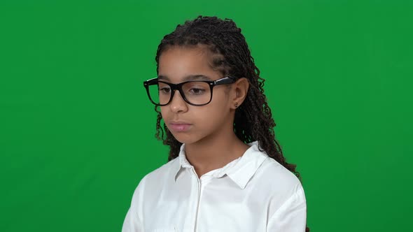 Upset Nerd African American Teen Girl Looking Away Shaking Head on Green Screen