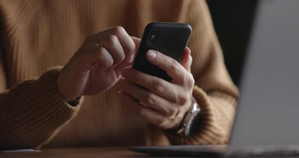 Close Up Shot of Man Hands with Watch Using Mobile Phone While Working at Laptop