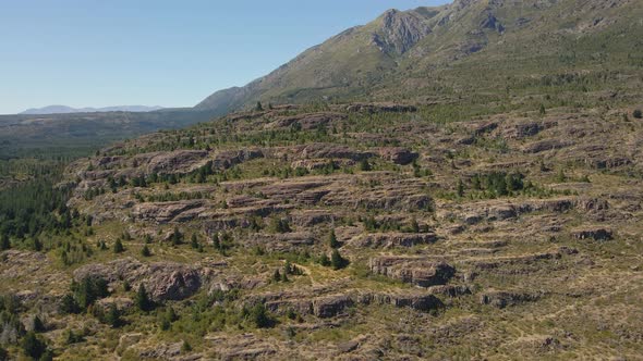 Aerial pan left of Andean mountains covered in vegetation near Epuyen lake, Patagonia Argentina