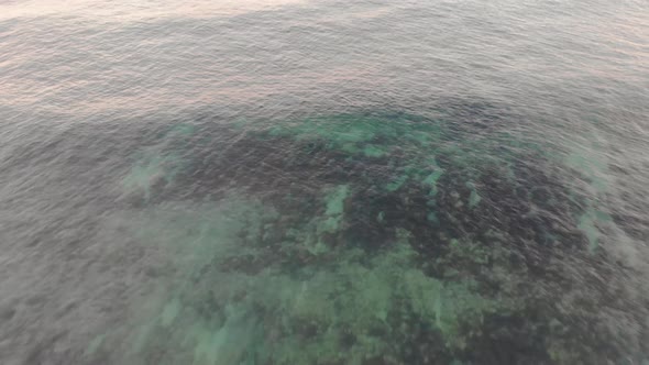 Drone flight over turquoise waters and sandy beach, Matadouro. Aerial backward tilt-up reveal