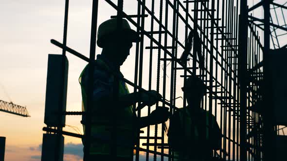 Building Employees Are Working with a Metal Carcass alt