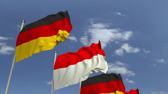 Flags of Indonesia and Germany Against Blue Sky