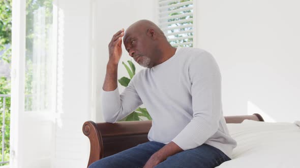 Tired african american senior man having headache