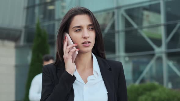 Young Business People On The Street. They Are Walking Down The Street. Girl Talking On The Phone.