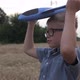 A happy boy launches a toy plane in a wheat field. Pilot of a children's plane. - VideoHive Item for Sale