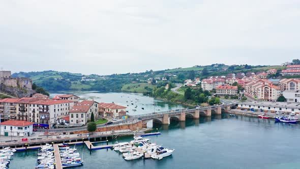 Scenic aerial view of traditional north spanish fishing village at both sides of sea entrance