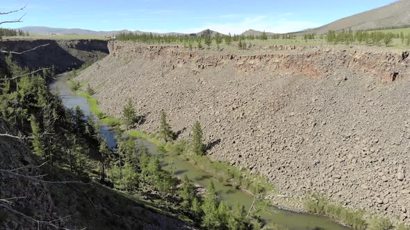 Broken Crumbled Rocks Spilling From the Narrow Canyon Slope Ridge Towards the Deep Valley Floor