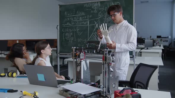 Teacher Holds the 3D Printed Hands and Explains Its Formula