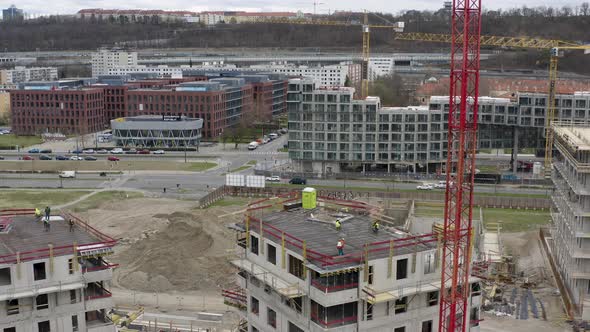 Construction workers on rooftops of unfinished buildings, Prague city.