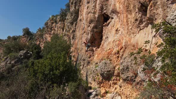 Drone Flying Along Limestone Cliff with Rock Climber on It