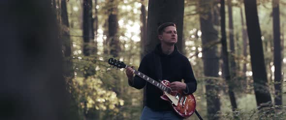 Guitar Player in the Woods
