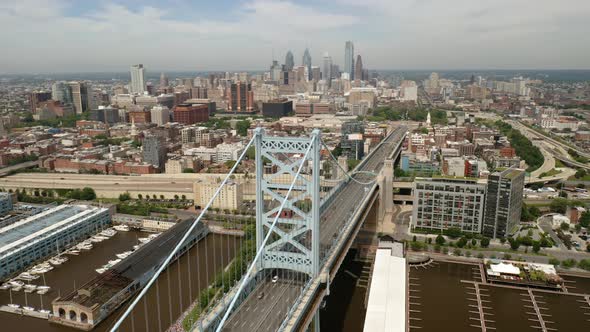 Aerial view timelapse rotating left showing the Philadelphia Ben Franklin Bridge and skyline in the