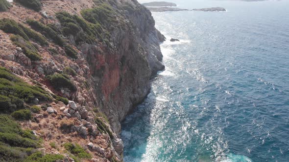 Aerial view of seaside cliff beach, foaming waves. Landscape Crete island Greece 