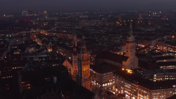 Flight Over the Rooftops of Munich City at Night in Germany Marienplatz and Beautiful Cathedrals