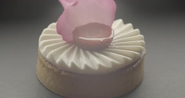 Shot of Tasty Sweet Round Dessert with White Cream Strawberry and Rose Petal