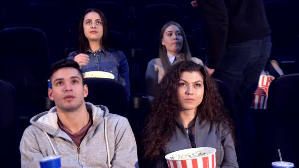 Man Takes His Place at the Movie Theater