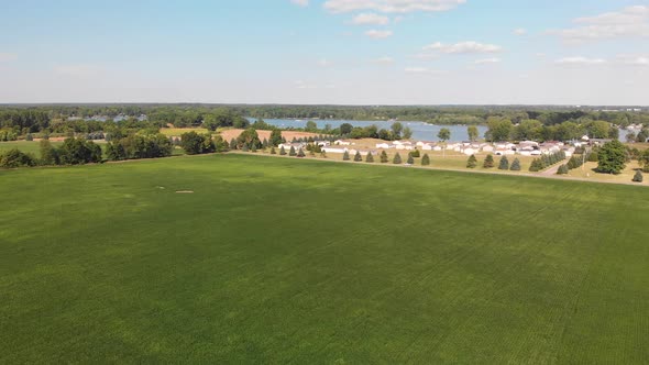  Countryside With Residential Buildings And Lake View. Aerial Landscape.