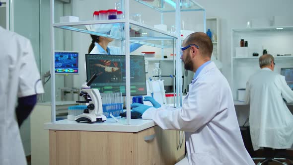 Multiethnic Team of Scientist Working in Medical Laboratory alt