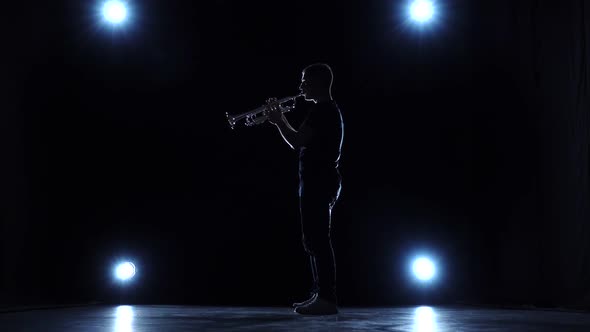 Trumpet Jazz Playing Musician in Studio with Spotlights. Slow Motion