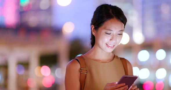 Woman use of mobile phone in the city at outdoor