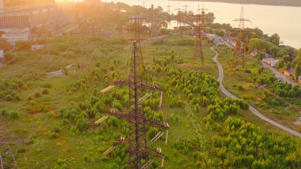 Power line pylons near the river. Electric towers with electric cables with high voltage current. 