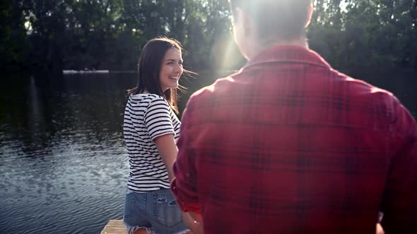 Happy young couple in love at lake