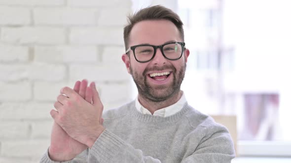 Portrait of Cheerful Creative Man Clapping