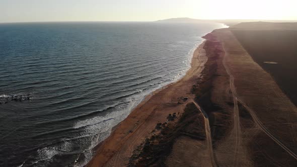 Aerial View of Flight Over Steep Rocky Coastline