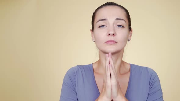 Portrait of Woman Praying and Begging with Funny Grimace, Asking for Something