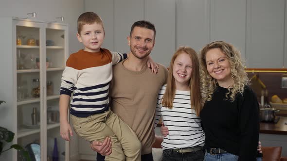 Portrait of Happy Family Posing on Camera at Home