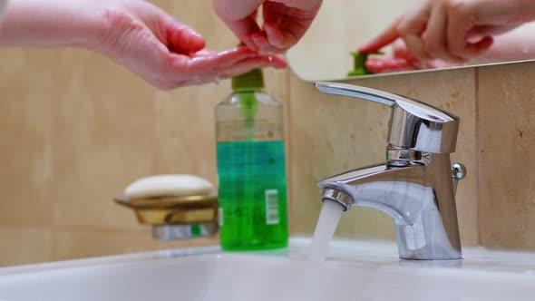 Woman Cleaning Her Hands with Antibacterial Soap