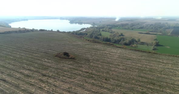 Crop Fields Flight Over Coming To A Lake Some Fields Are Burning