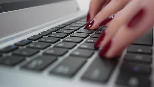 Extreme Closeup Female Fingers Typing on Keyboard