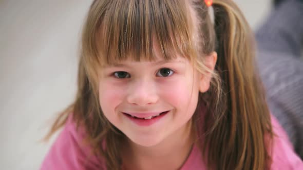 Portrait of Pretty Little Child Girl Happily Smiling in Camera