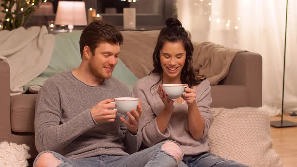 Happy Couple Drinking Hot Chocolate at Home