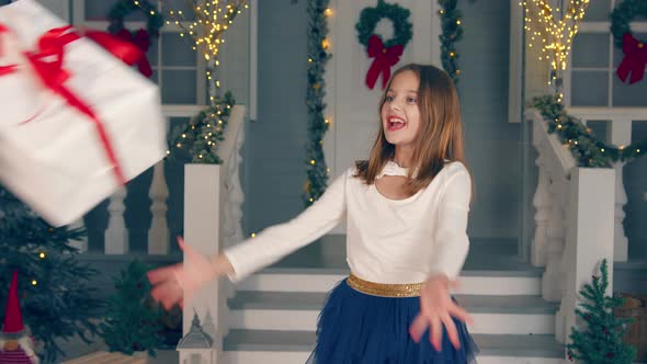 Little Girl Catches a Gift in a Big Box