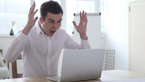 Screaming Angry Businessman Working on Laptop