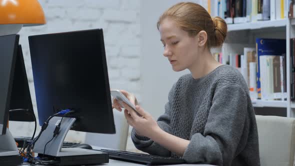 Redhead Woman Browsing Internet Online on Smartphone