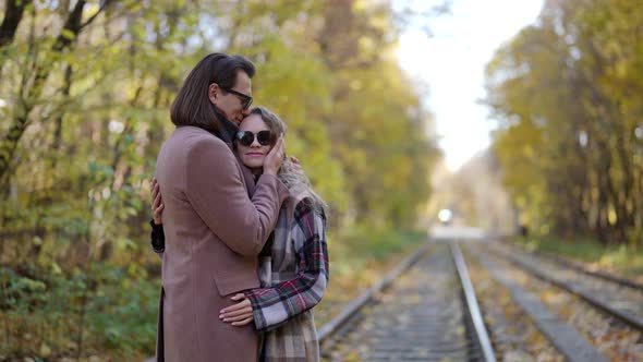 Embracing Couple on Tram Track in Autumn Day Lovers are Hugging