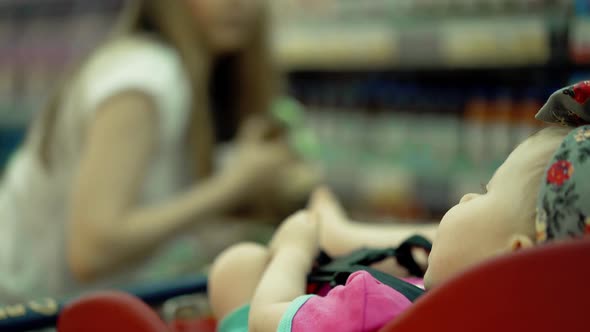 Child Sits in a Specially Equipped Chair 9 in the Supermarket 5