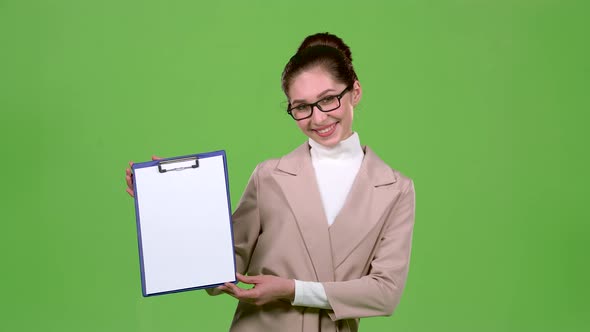 Girl Advertising Agent Shows Important Information on the Tablet. Green Screen. Slow Motion