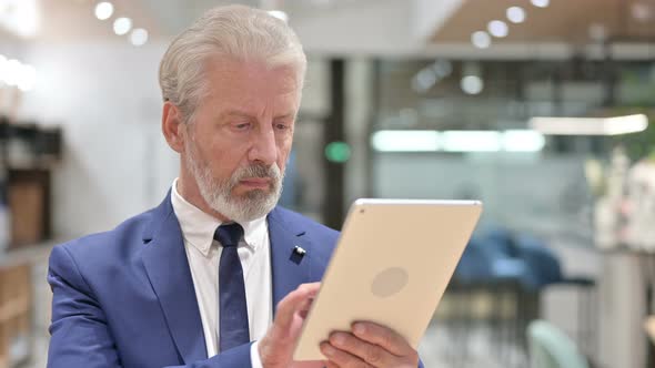 Senior Old Businessman Using Digital Tablet